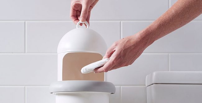 A person disposing sanitary waste into Pod Classic Manual unit