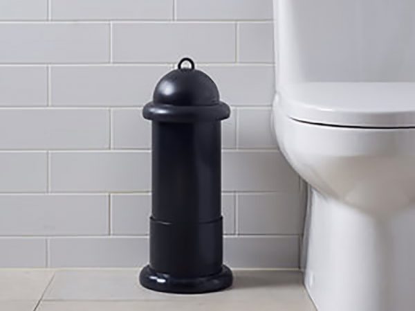 A black Pod Classic Mini Manual on a Pod Stand beside a toilet