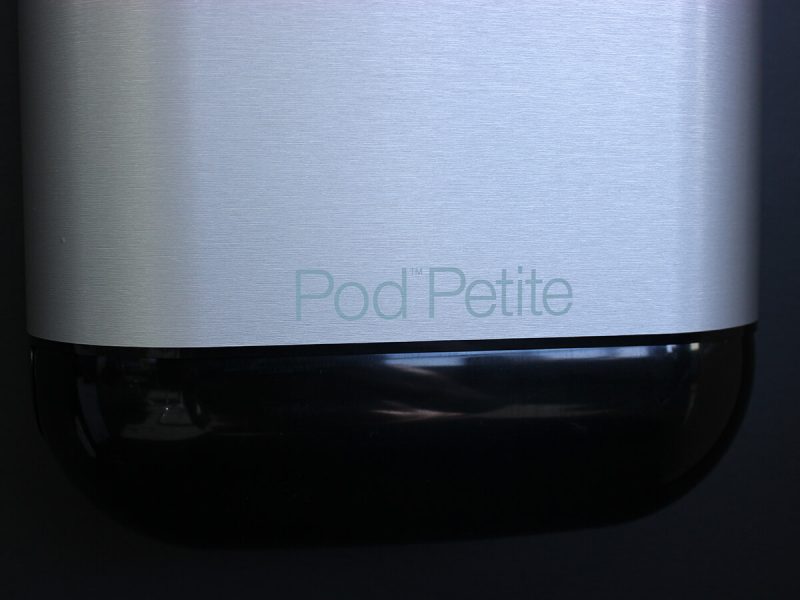 A close-up shot of Pod Petite black sanitary unit with Pod Wrap Stainless Silver decal