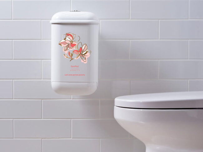 A white Pod Petite sanitary disposal unit with a Pod Wrap SaniPod x Dignity decal.