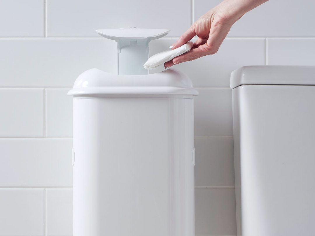A person disposing sanitary waste into Pod Petite sanitary pad disposal automatic unit