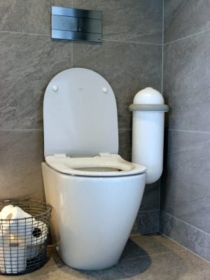 The Pod Classic Mini placed next to a toilet