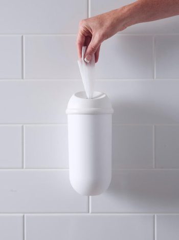 The Wet Wipe dispenser installed on a white tiled wall.
