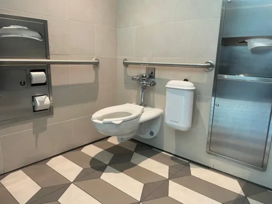 Pod Petite Auto Sanitary White Sanitary Unit in a Walt Disney Parks & Resorts Accessible Restroom
