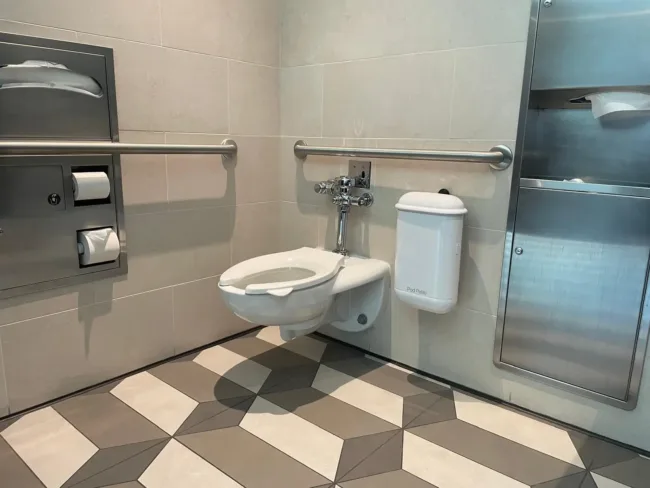 Pod Petite Auto Sanitary White Sanitary Unit in a Walt Disney Parks & Resorts Accessible Restroom