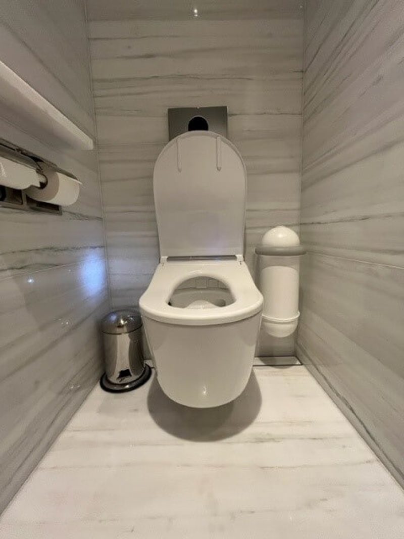 The Peninsula, London hotel washroom cubicle with SaniPod Pod Classic Mini Auto white sanitary disposal unit