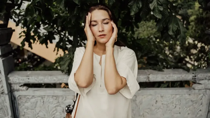 perimenopause - woman outdoors with closed eyes